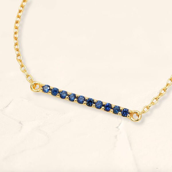 Long bar bracelet with rubies in yellow gold