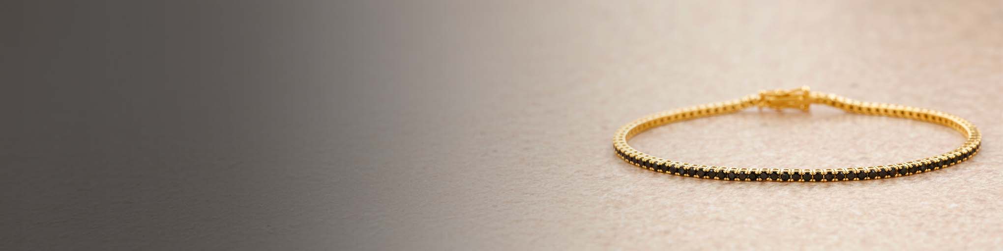 Black diamond tennis bracelet set on yellow gold 18K, elegant fine jewellery on beige gradient background