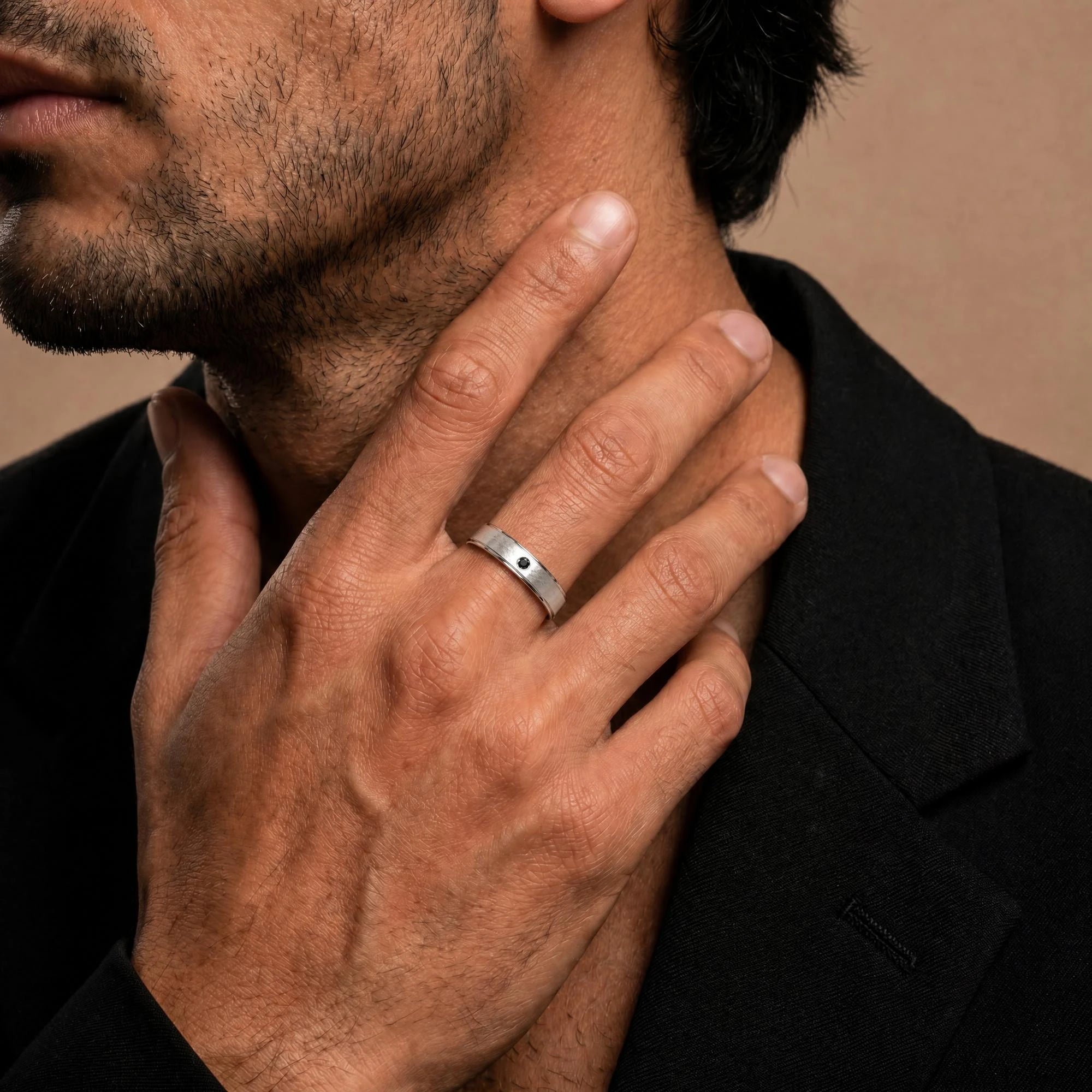 Dhruva black diamond band in white gold worn by a man, brushed band