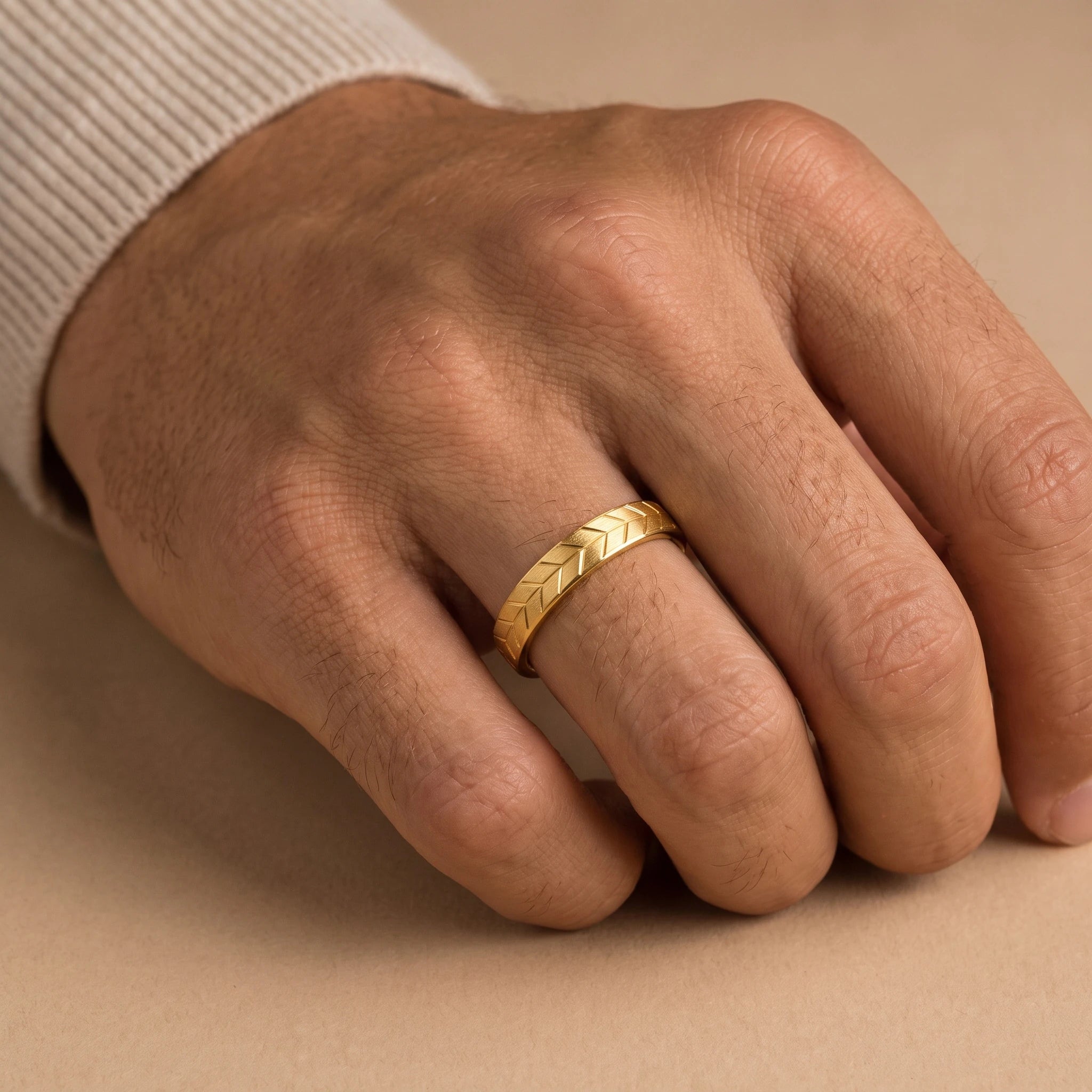 Men's chevron engraved wedding ring yellow gold 18K Maât, worn close-up