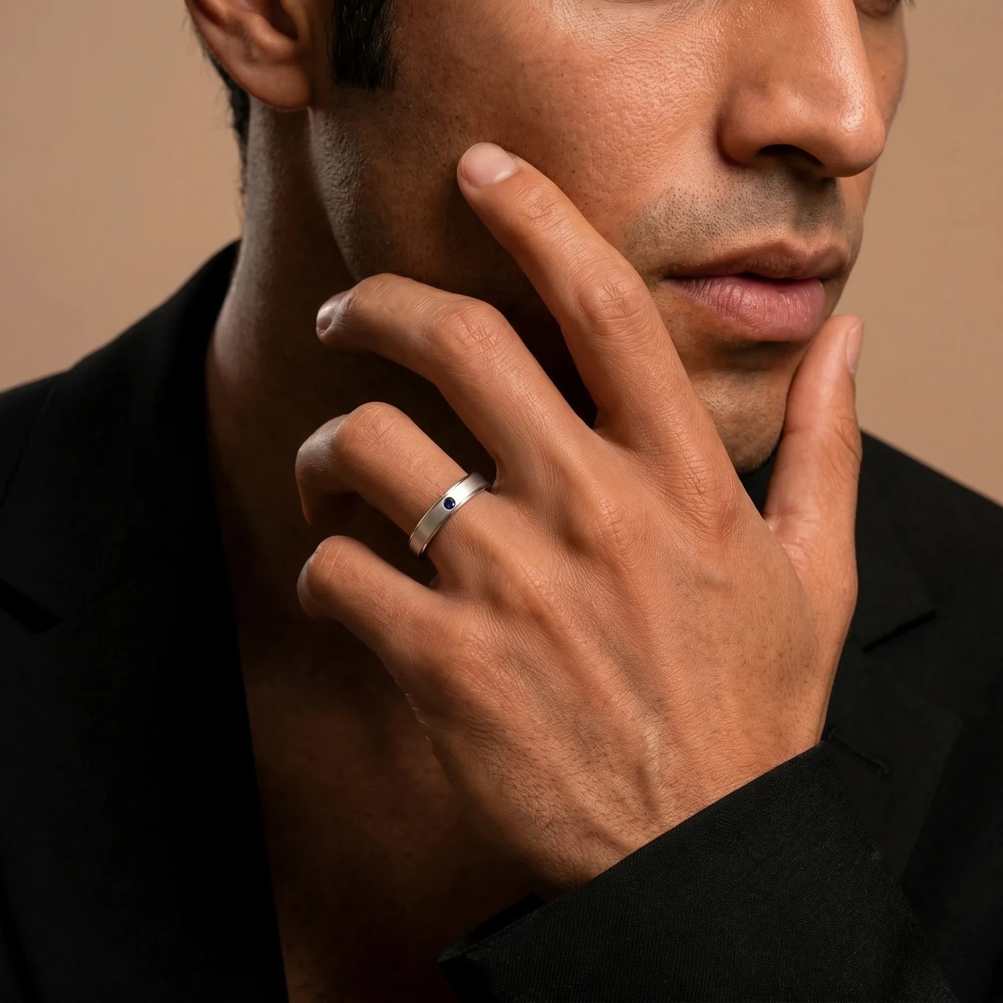 Dhruva sapphire band in white gold worn by a man, brushed band