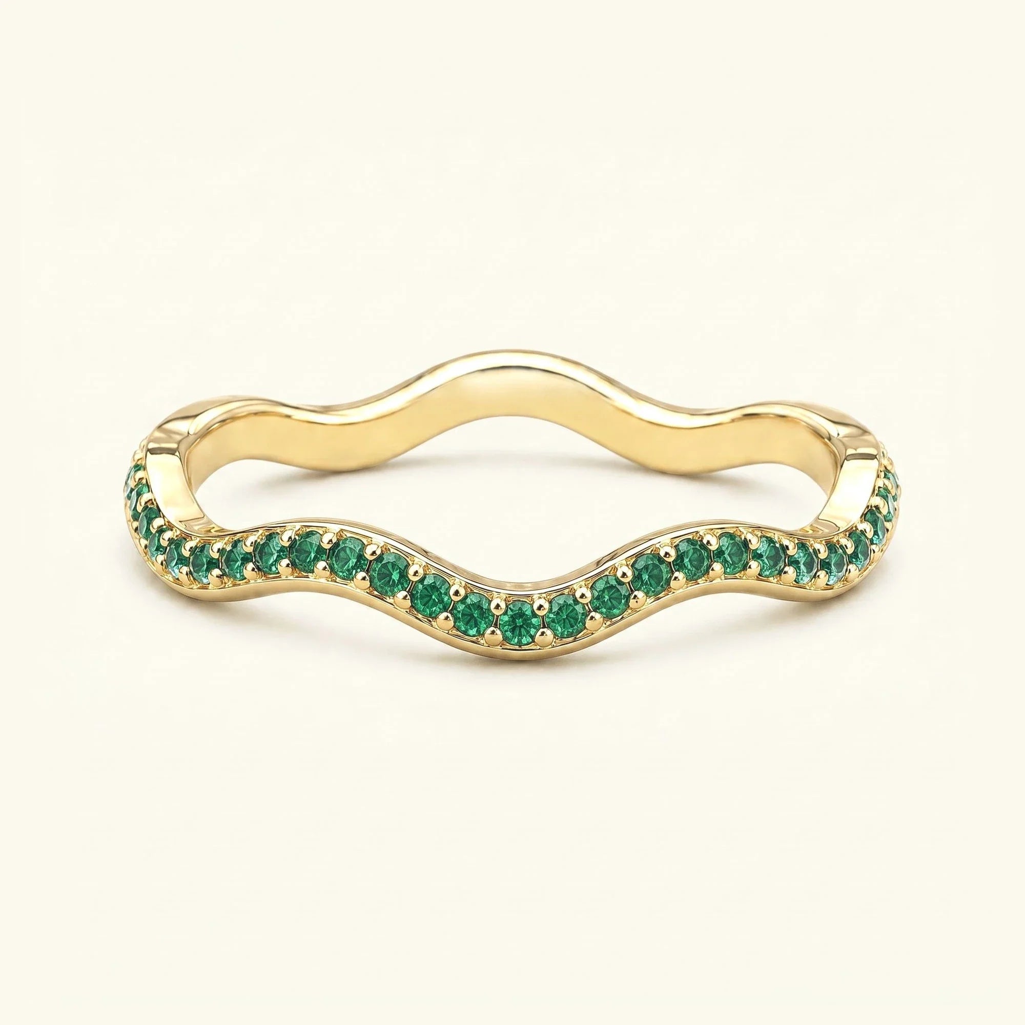 Thalassa wave wedding ring with emeralds in 18K yellow gold, half-eternity pavé set