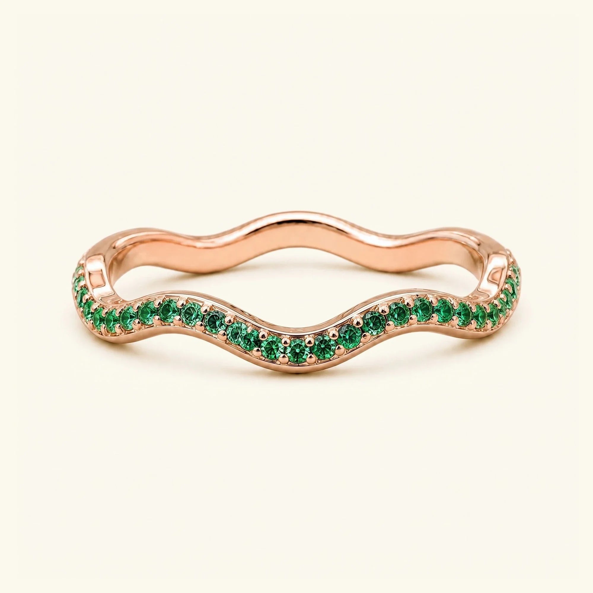 Thalassa wave wedding ring with emeralds in 18K rose gold, half-eternity pavé set