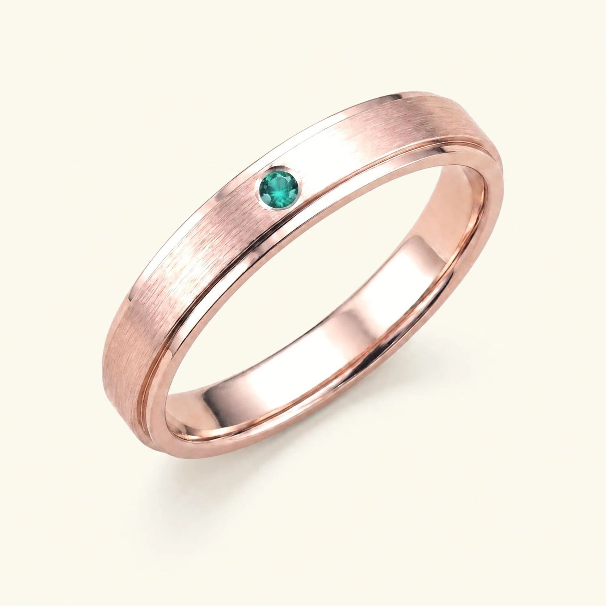 Dhruva emerald wedding band in 18k rose gold, brushed band bezel setting