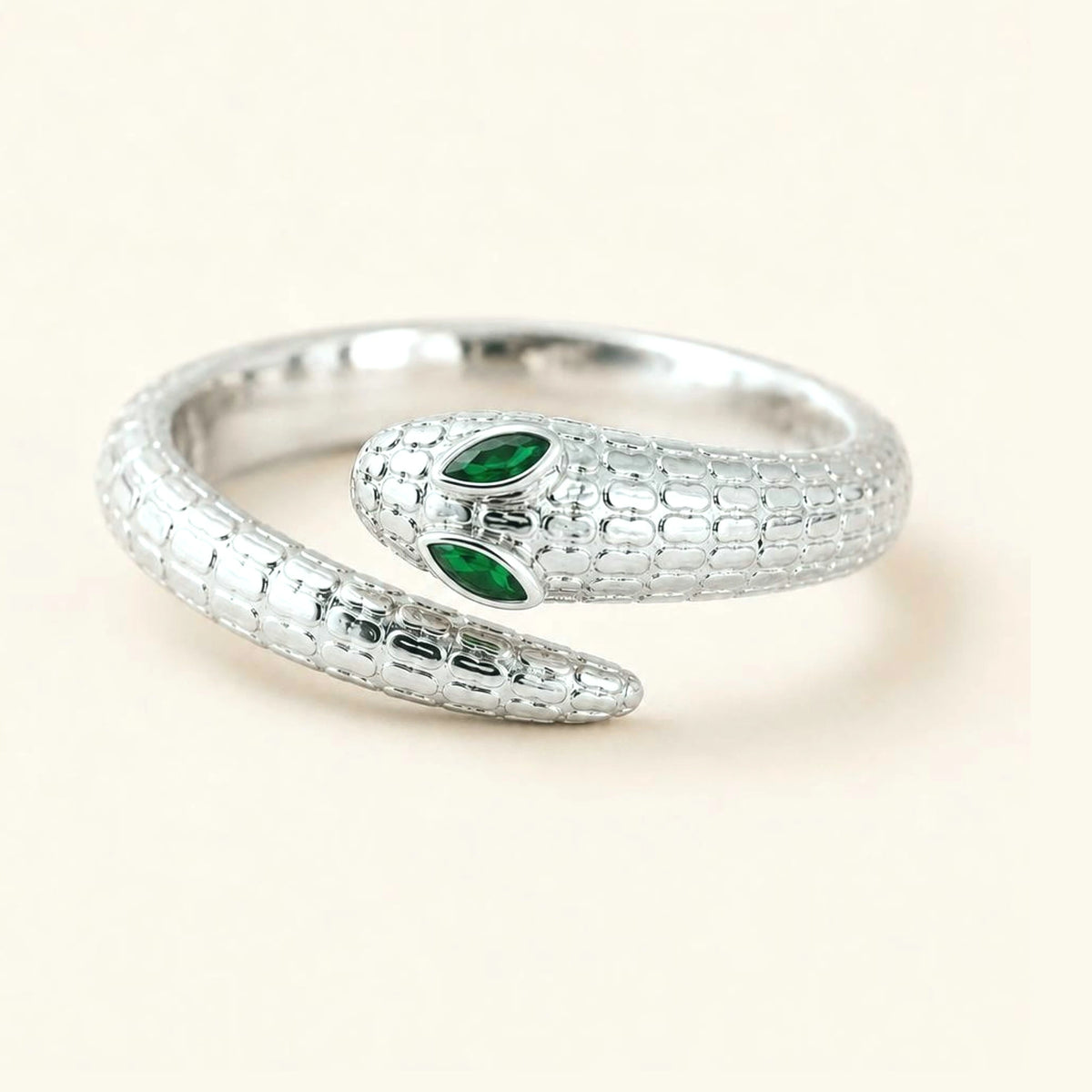 Méhen snake ring in 18K white gold, scaled body and marquise emerald eyes