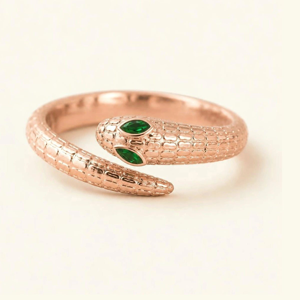 Méhen snake ring in 18K rose gold, scaled body and marquise emerald eyes