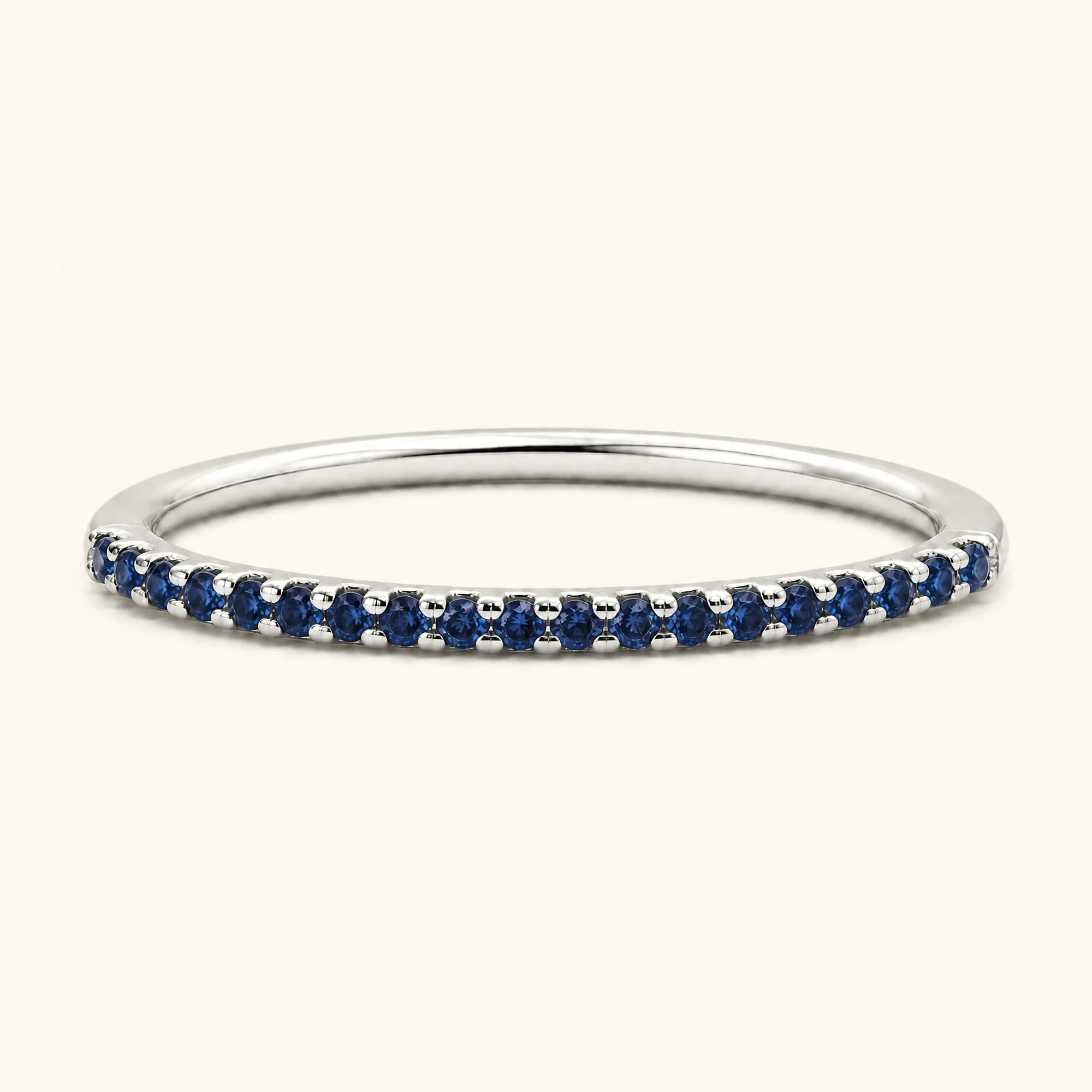Eternity sapphire ring half-way pavé set in white gold