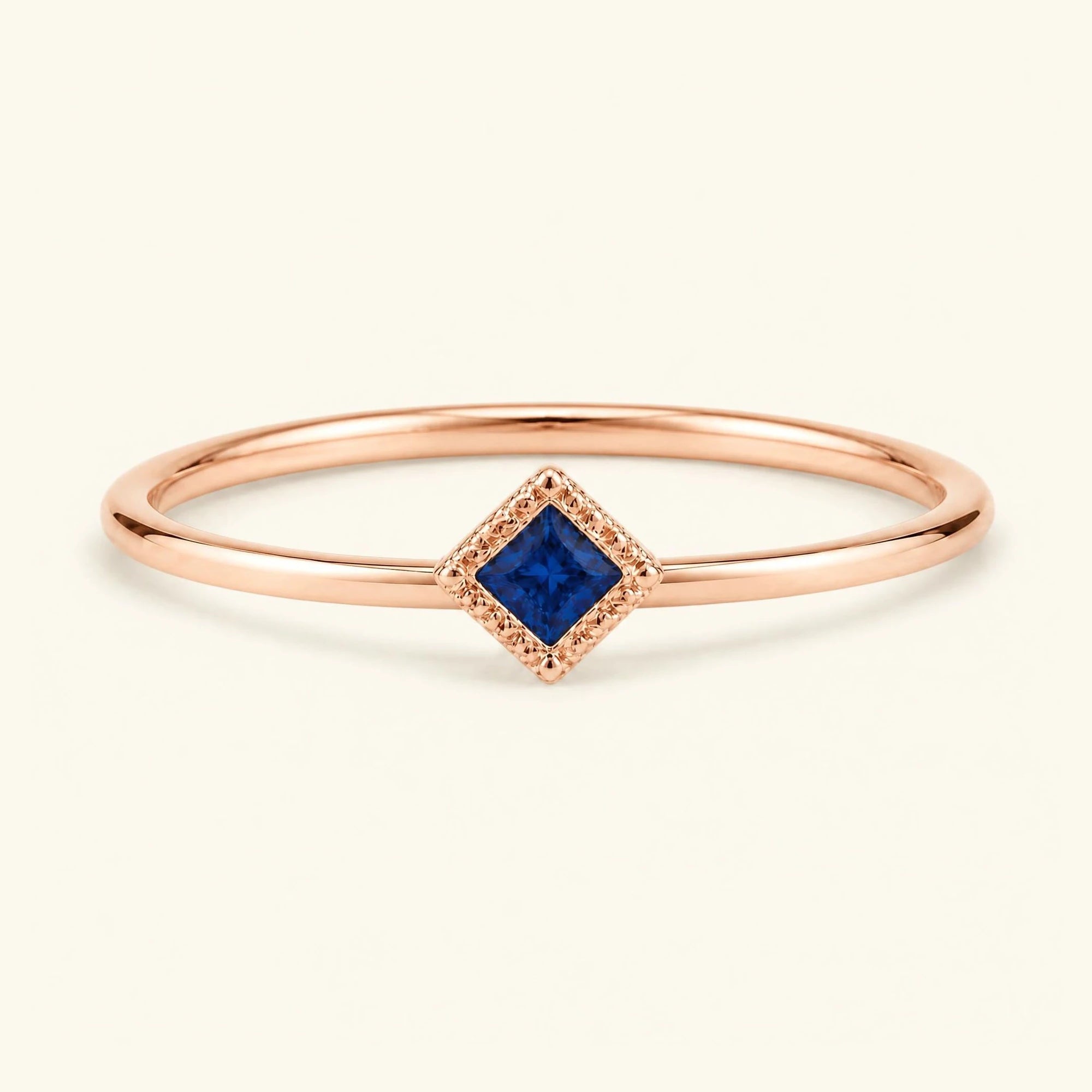 Vintage Indrani engagement ring — sapphire solitaire princess cut 4 mm, square stone in twisted rope setting, 18K rose gold