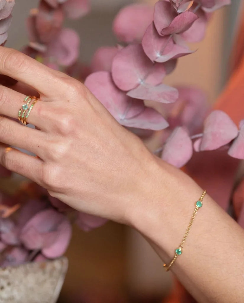 Dhanya bracelet in emerald and yellow gold worn on the wrist, a maid of honor gift idea
