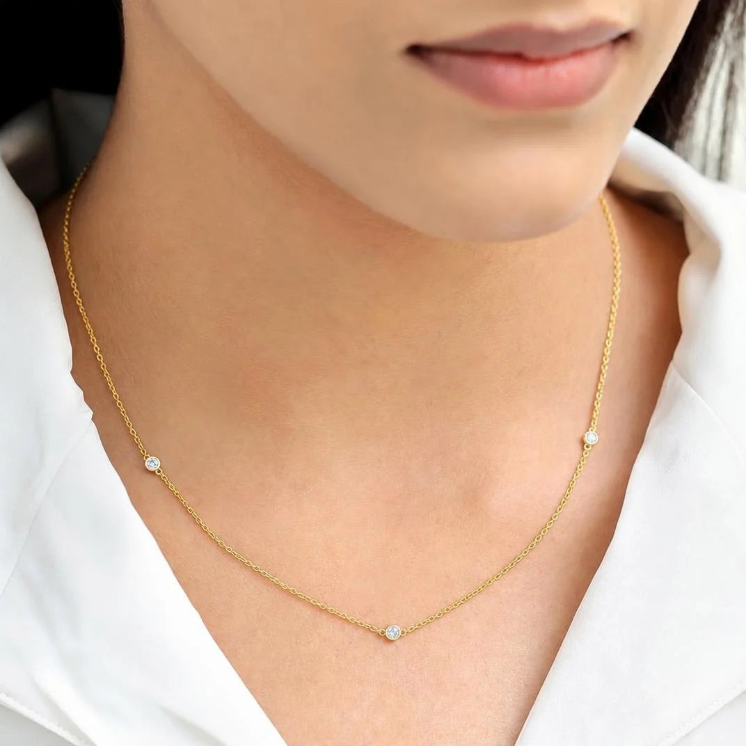 Asonya diamond choker necklace worn by a woman, fine gold chain with bezel-set diamonds