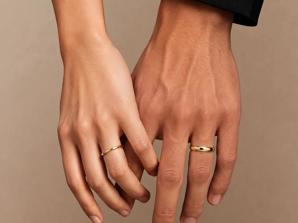 Shunya couple wedding rings in 18K yellow gold, worn on a woman's hand and a man's hand