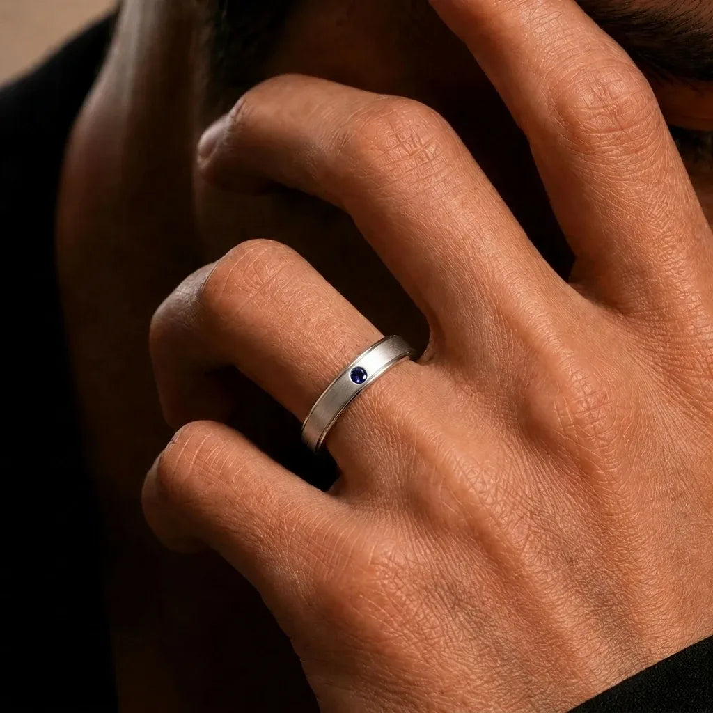 18K White Gold bangle set with a blue Sapphire, worn on the finger, by Mayuri