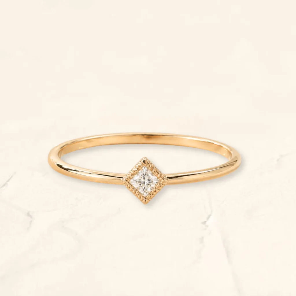 The Indrani ring in 18K yellow gold, set with a princess cut Diamond with milgrain prongs, by Mayuri