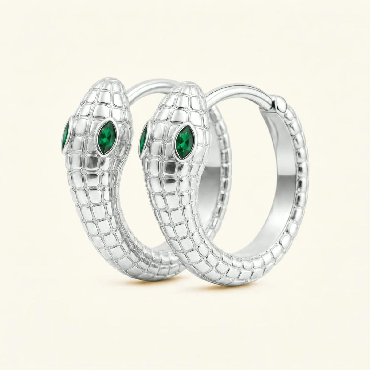 Méhen snake hoop earrings in 18K white gold, scaled body and marquise emerald eyes