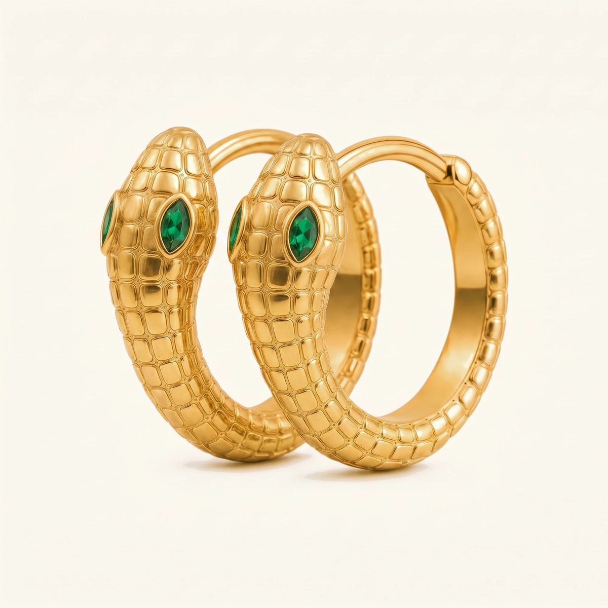 Méhen snake hoop earrings in 18K yellow gold, scaled body coiled into a hoop and marquise emerald eyes