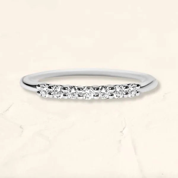 Emerald solitaire ring in 18K yellow gold worn on the finger, showing the visual effect on the hand