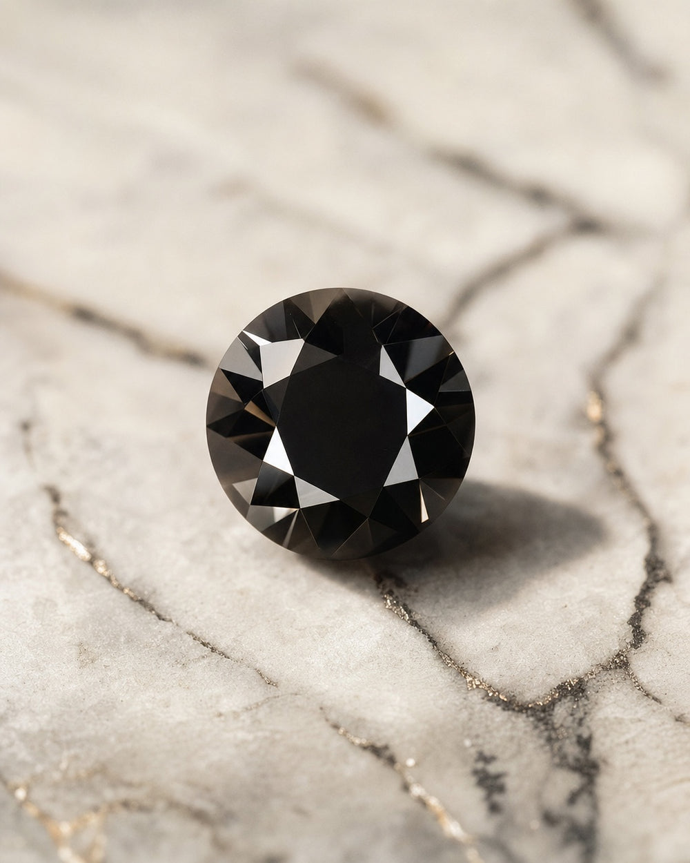 Brilliant cut black diamond resting on light veined marble, high contrast