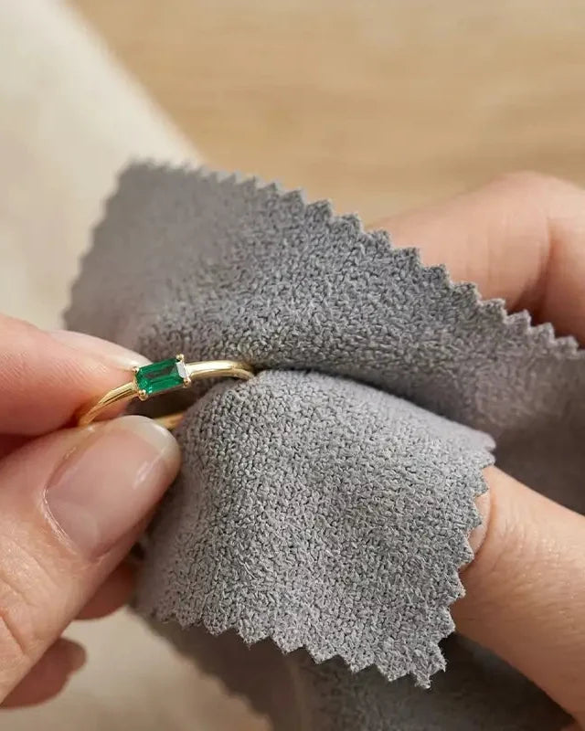 18K yellow gold ring set with an emerald, gently cleaned with a soft grey microfibre cloth