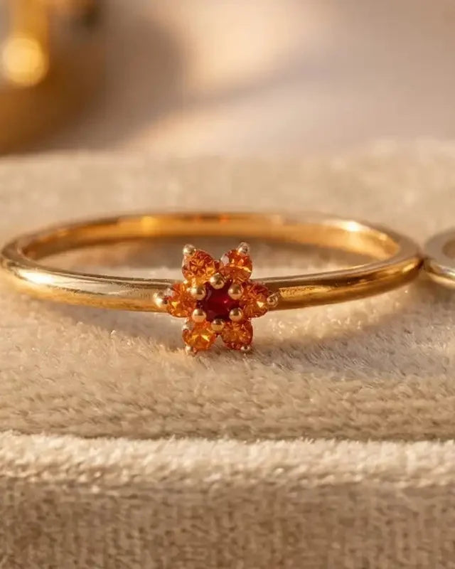 Flower ring in 18K yellow gold set with orange sapphires and a central ruby, Mayuri fine jewellery