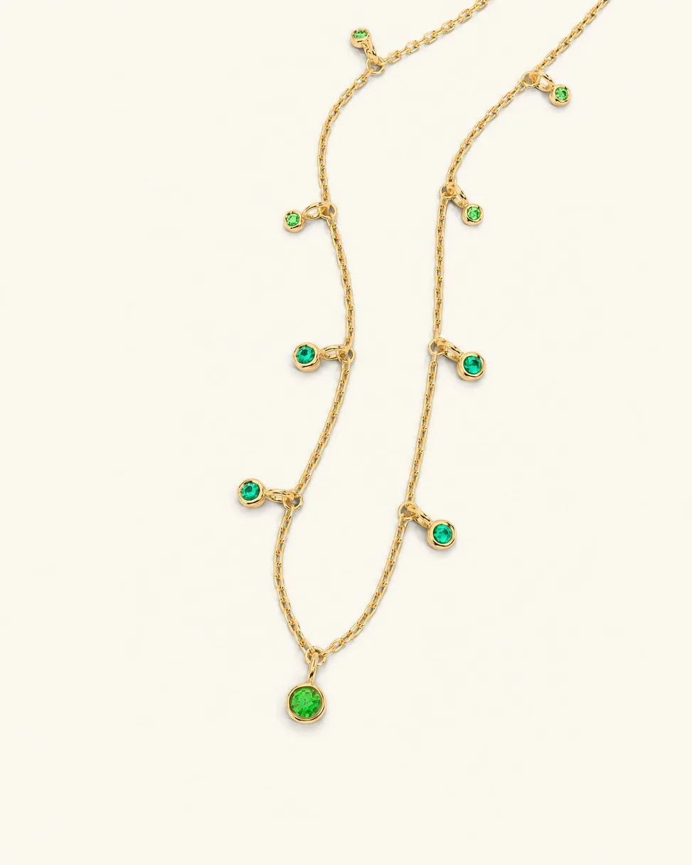 Megha necklace in yellow gold with emerald and tsavorite pendants, Émeraude Canopée gradient on cream