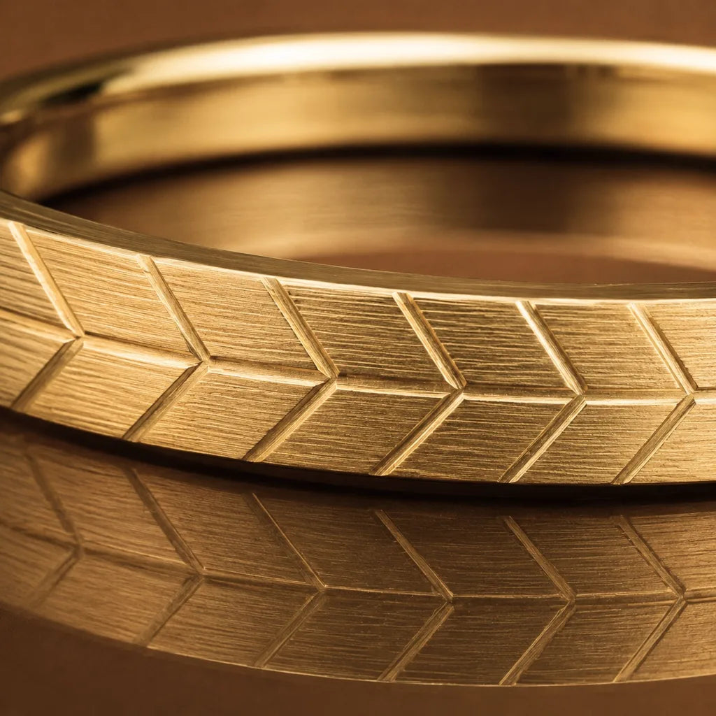 The Maat wedding ring in 18K yellow gold with detailed chevron engraving, showcasing the precision of Mayuri's precious metalwork