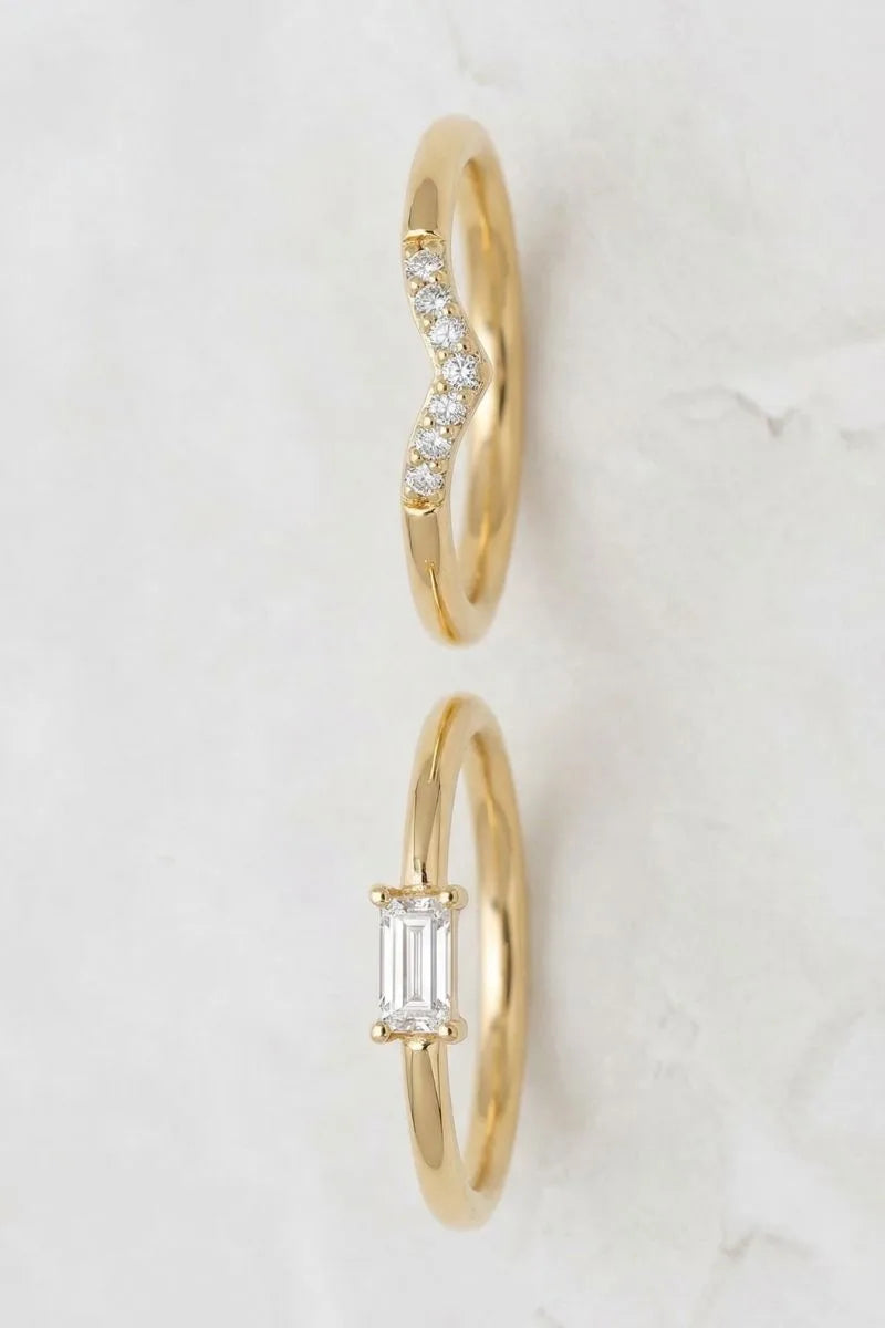 Two 18K yellow gold engagement rings with diamonds, showcasing different setting styles by Mayuri