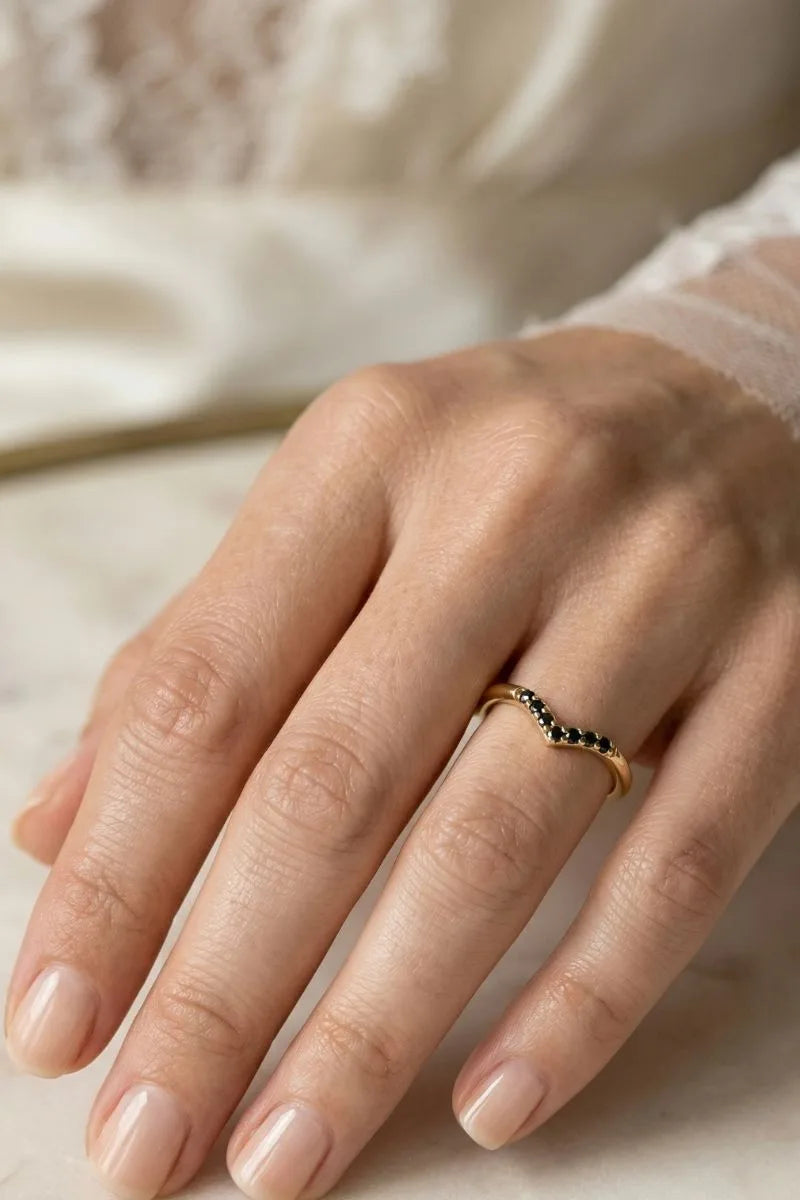 Black Diamond chevron engagement ring in 18K yellow gold worn on the finger, by Mayuri
