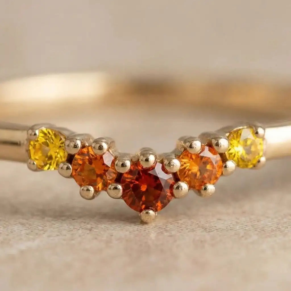 The Mayuri Sunset Sapphire collection, a jewel showcasing its characteristic orange-to-yellow gradient