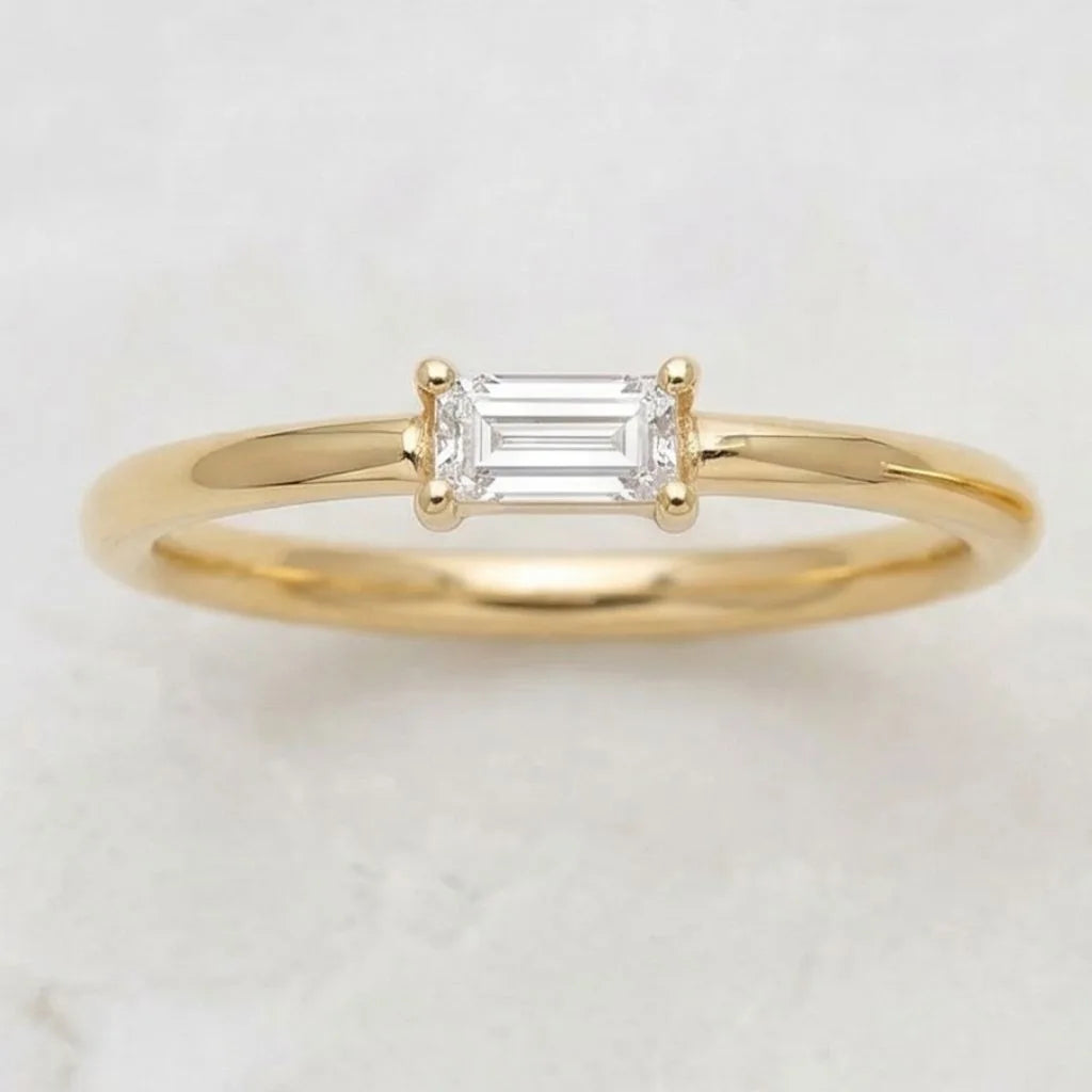 Mayuri baguette cut diamond solitaire ring in 18K yellow gold, minimalist and elegant design